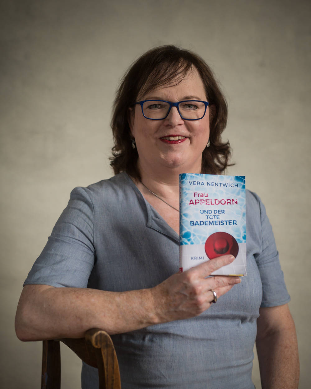 Vera Nentwich im Hochformat mit dem Buch Frau Appeldorn und der tote Bademeister, Foto: Thomas Nentwich